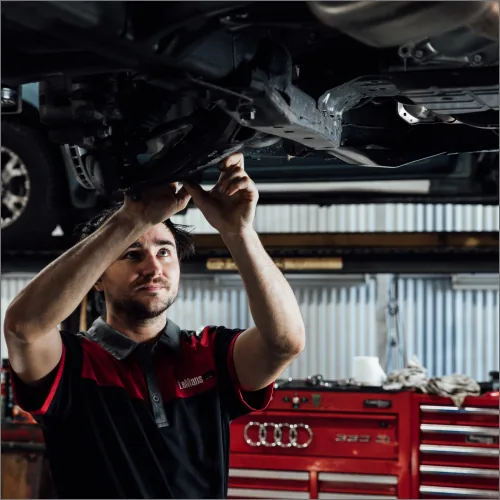 Mechanic performing log book service on European car at Brisbane workshop