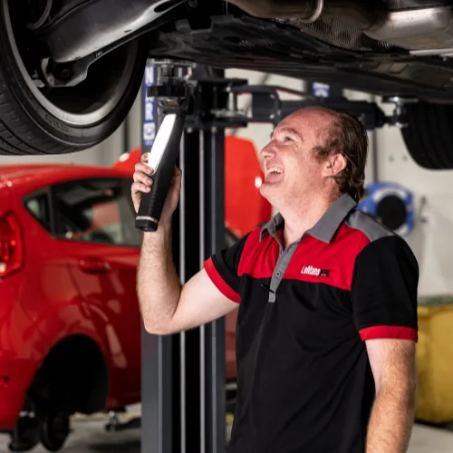 Qualified Bosch mechanic inspecting European car undercarriage during professional service in Brisbane workshop
