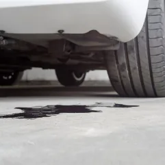 Car engine oil leak inspection underneath European vehicle at Brisbane workshop