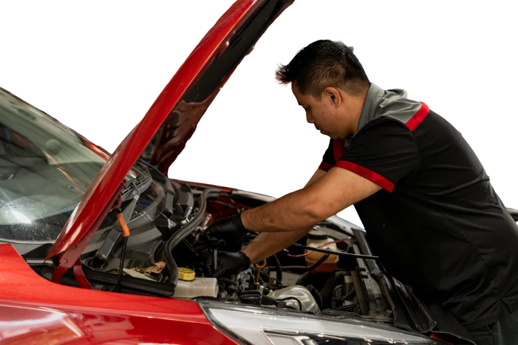 Mechanic servicing red European car engine under bonnet at Brisbane workshop