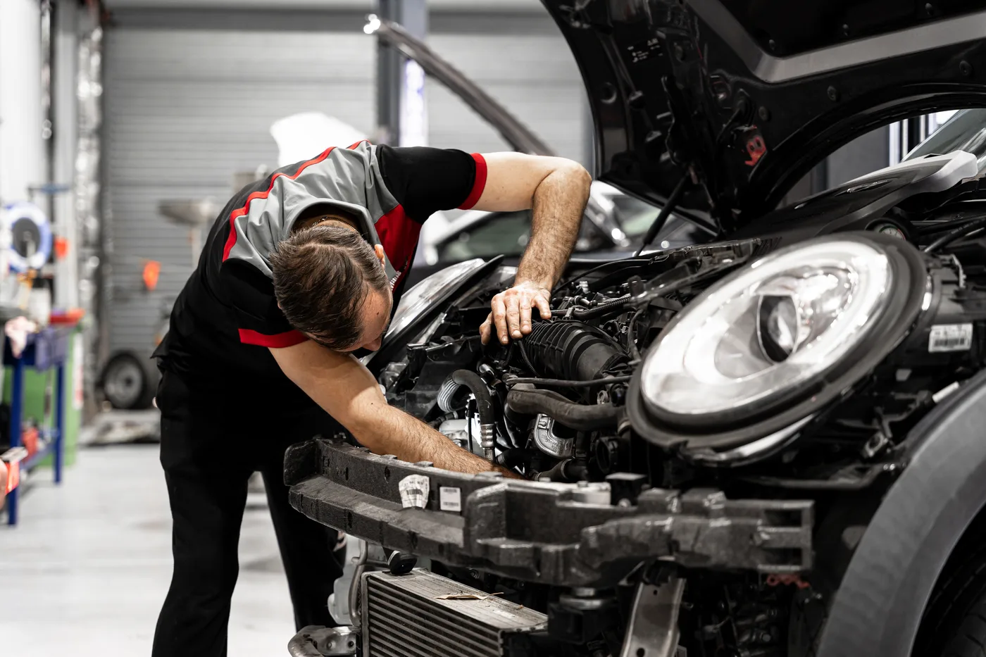 Bosch Service Brisbane technician testing the battery and charging system in a European car engine bay