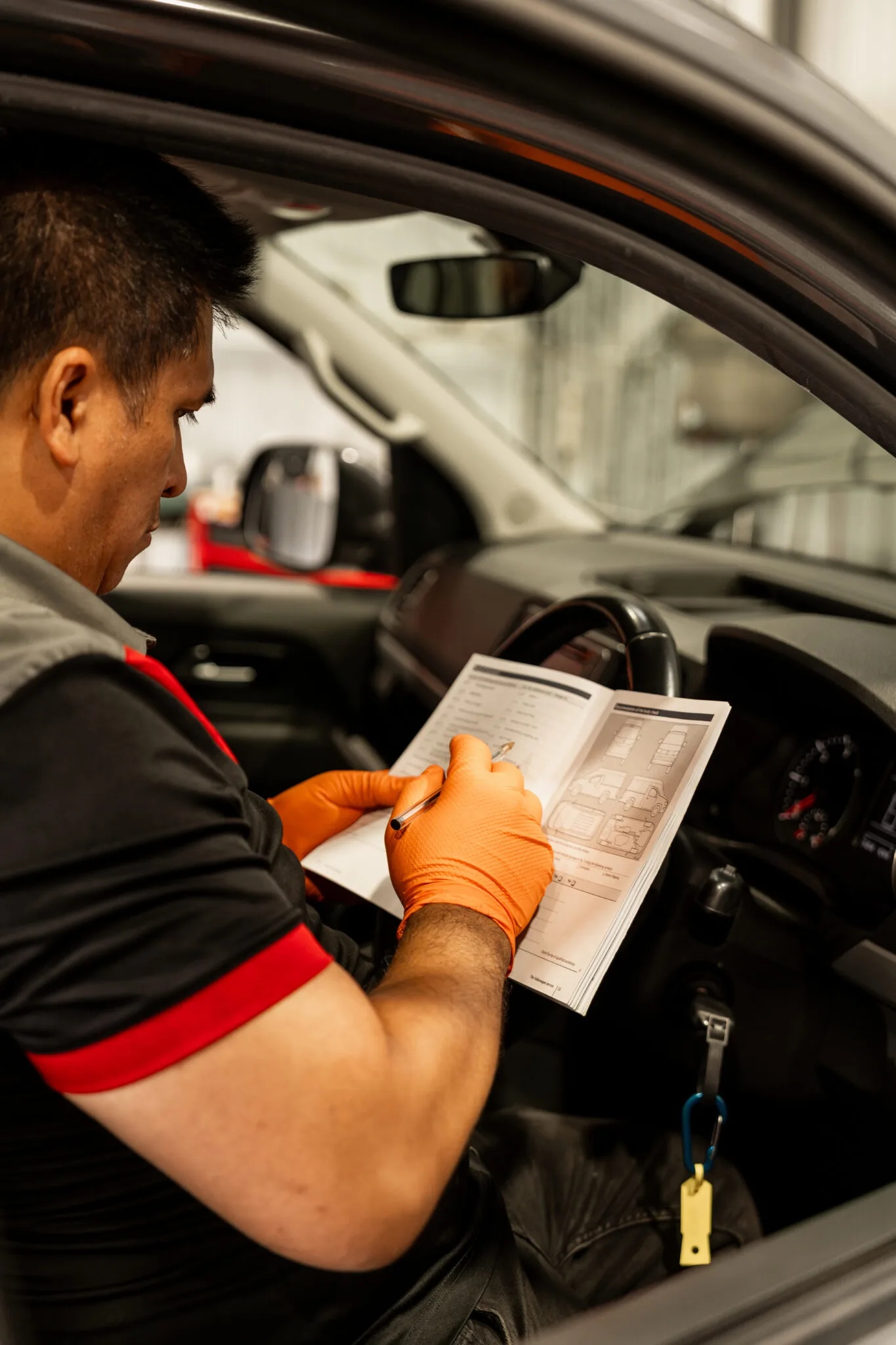 Bosch Service Brisbane mechanic completing a pre-purchase inspection checklist inside a vehicle