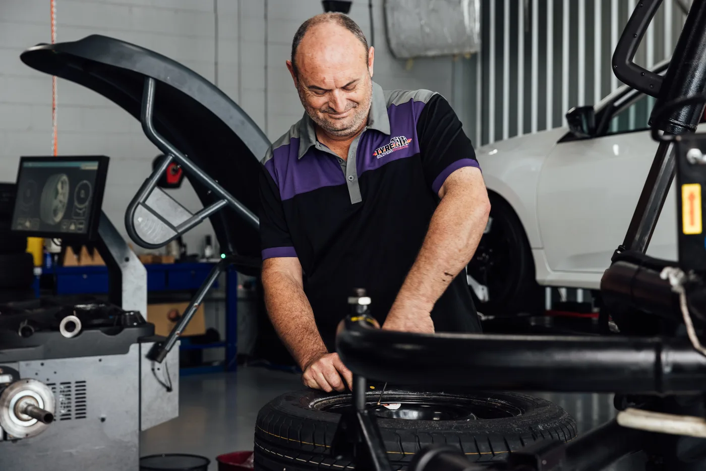 Bosch Service Brisbane technician checking a tyre, one of the most common QLD roadworthy failure points